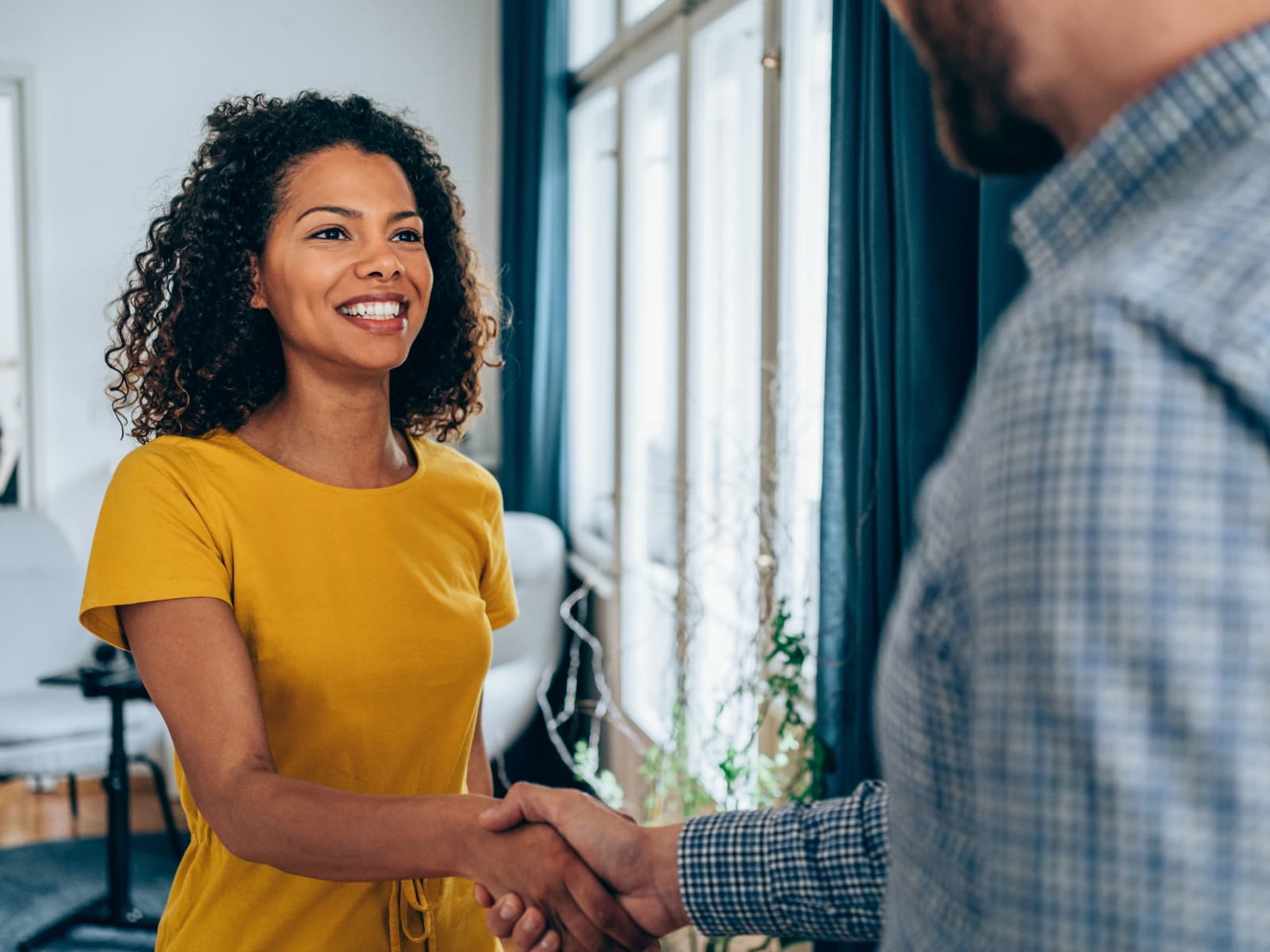 Two people greeting one another as they begin a partnership