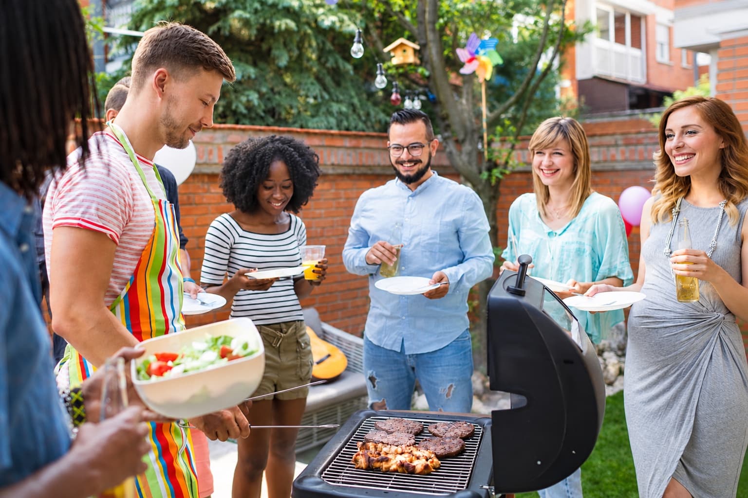 Friends sharing food and conversation at an outdoor gathering
